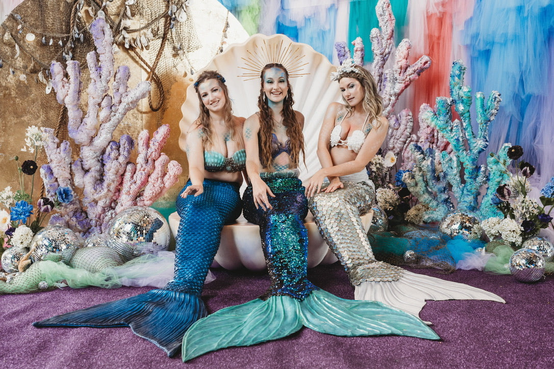 Dry land mermaid performers on throne