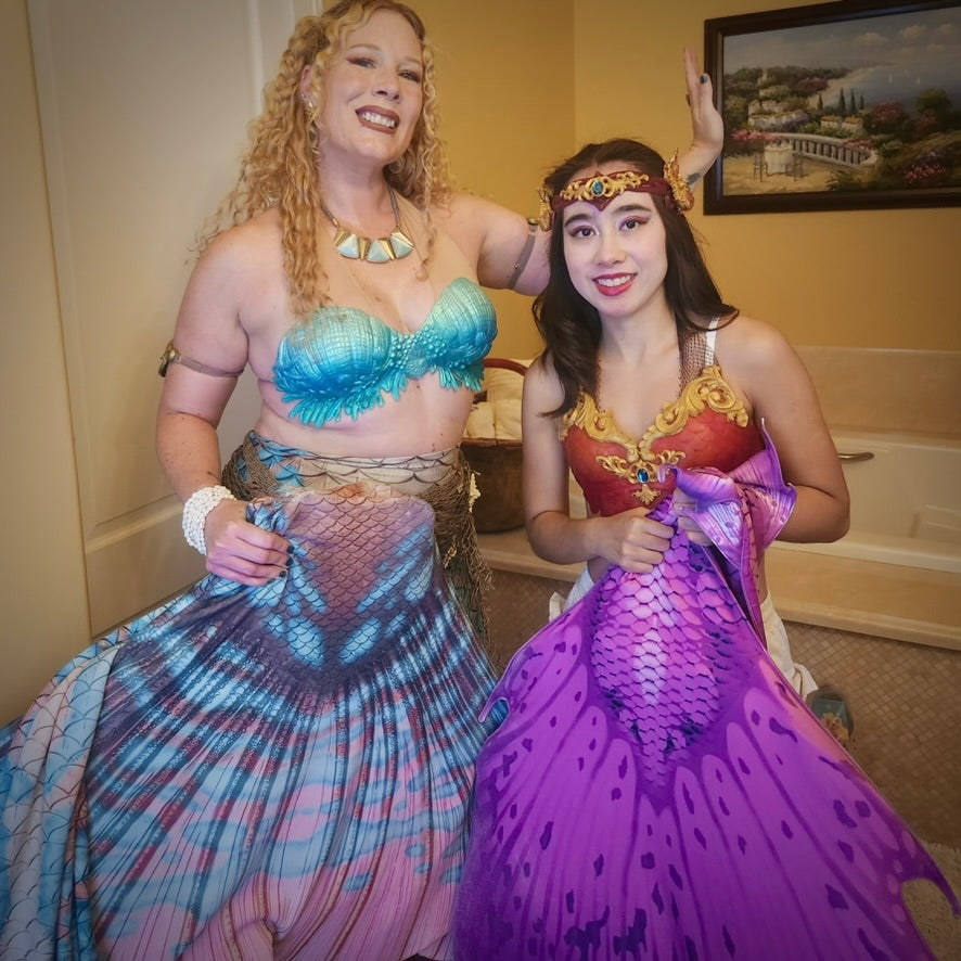 Two AquaMermaid performers backstage in costume