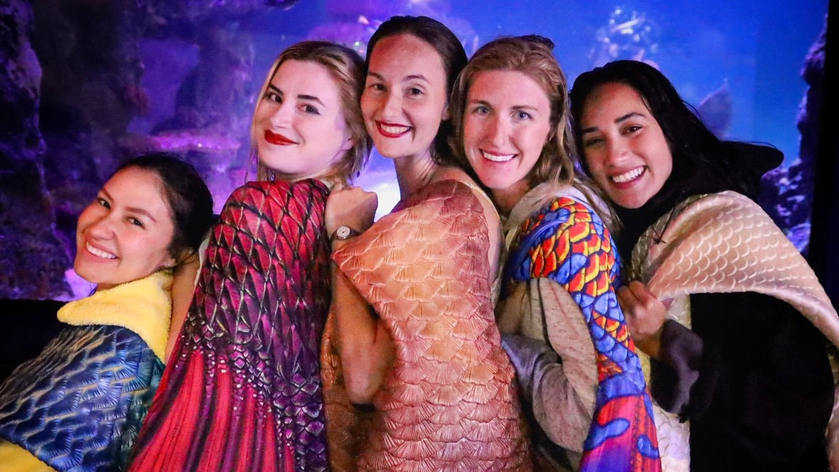 AquaMermaid team group photo at an aquarium event