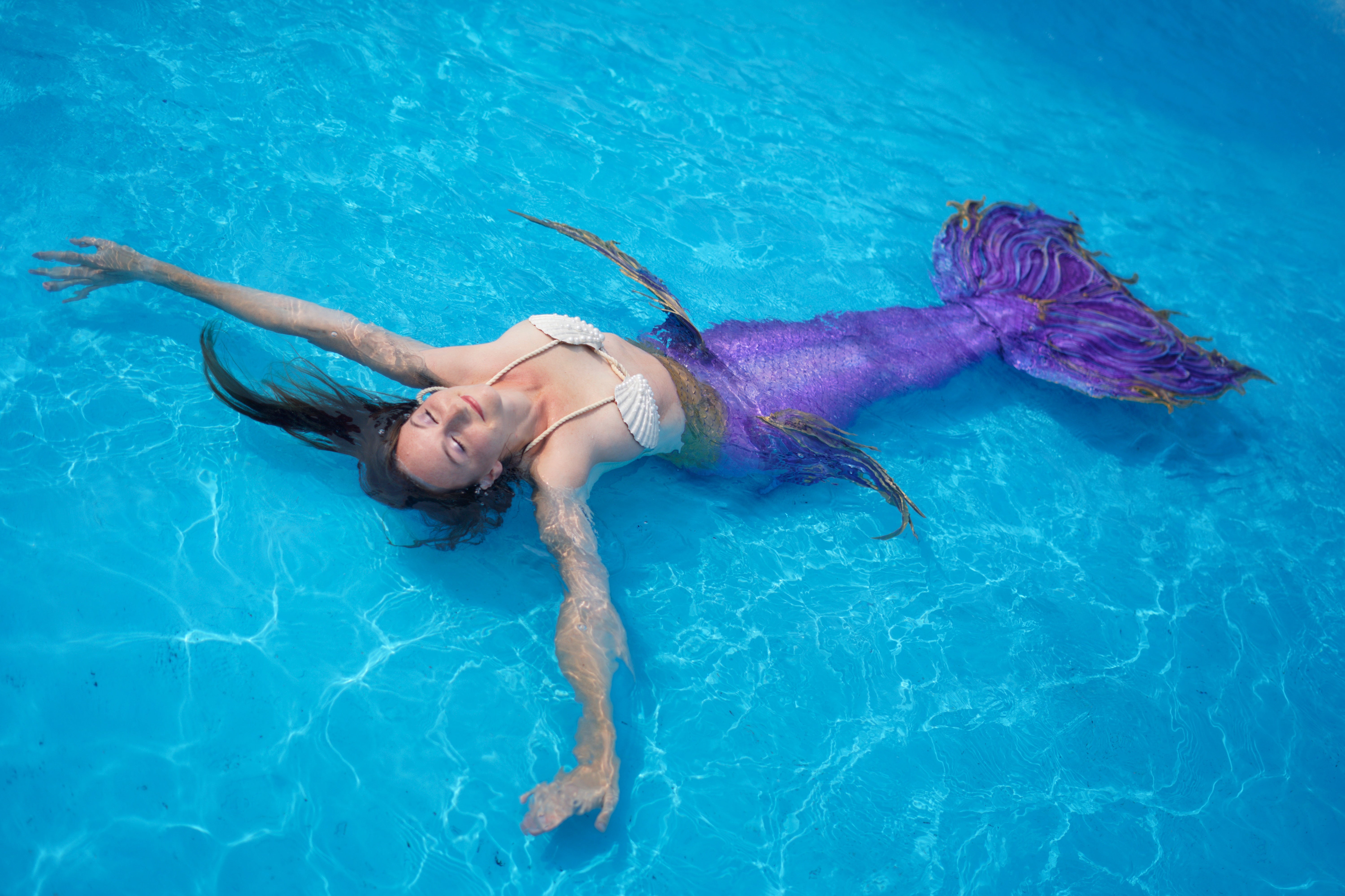 Mermaid performer floating in pool in Las Vegas
