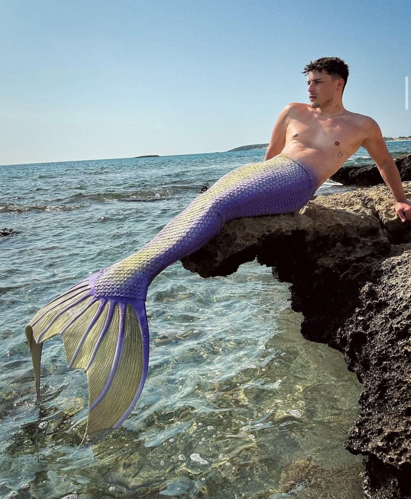 Merman on rocky coast