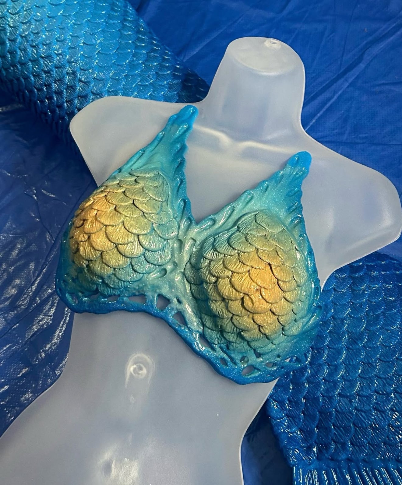 Luna silicone mermaid top with intricate fish-scale design in teal and gold